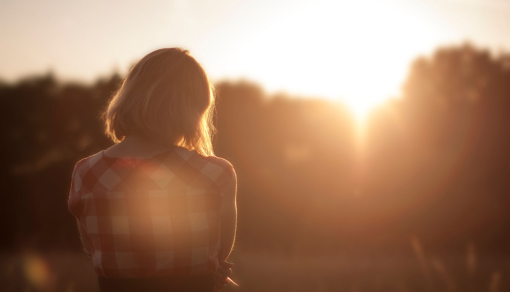 Woman looking to sunset